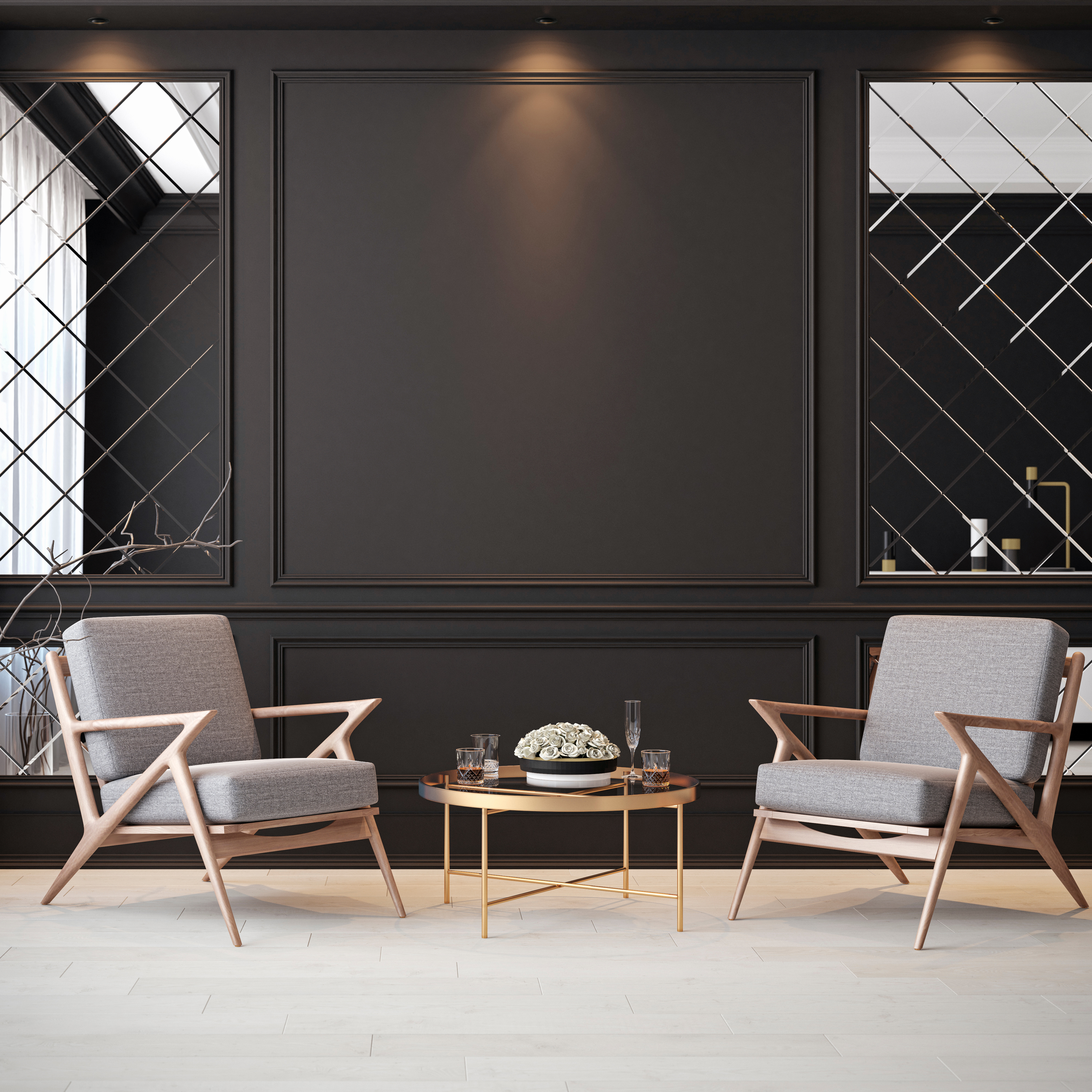 Modernes Wohnzimmer mit zwei grauen Sesseln mit Holzgestell und einem runden Couchtisch mit dekorativen Blumen.