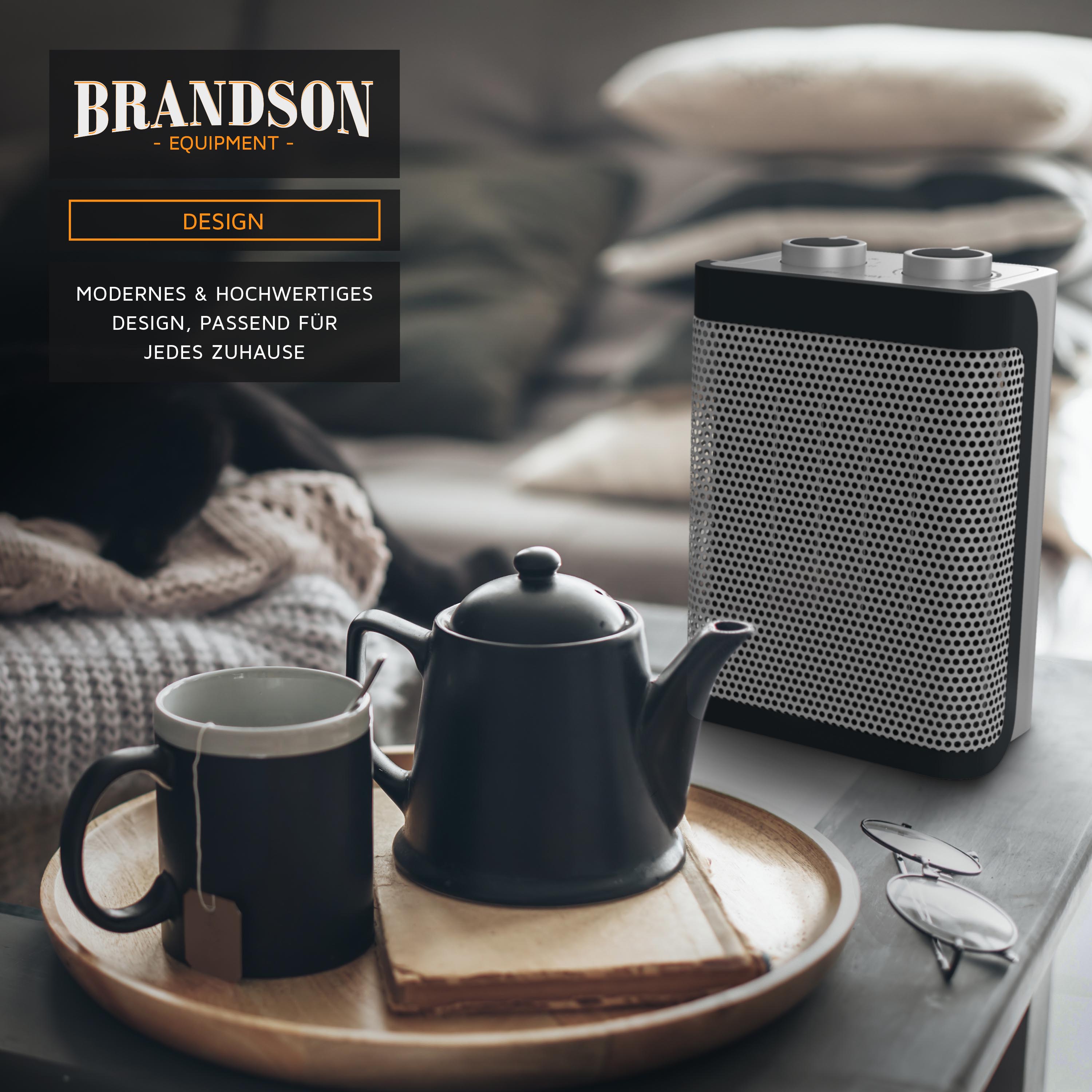 Brandson Heizlüfter mit modernem Design, schwarzem Gehäuse und runder Oberseite, platziert auf einem Tisch neben einer Teekanne und Tassen.