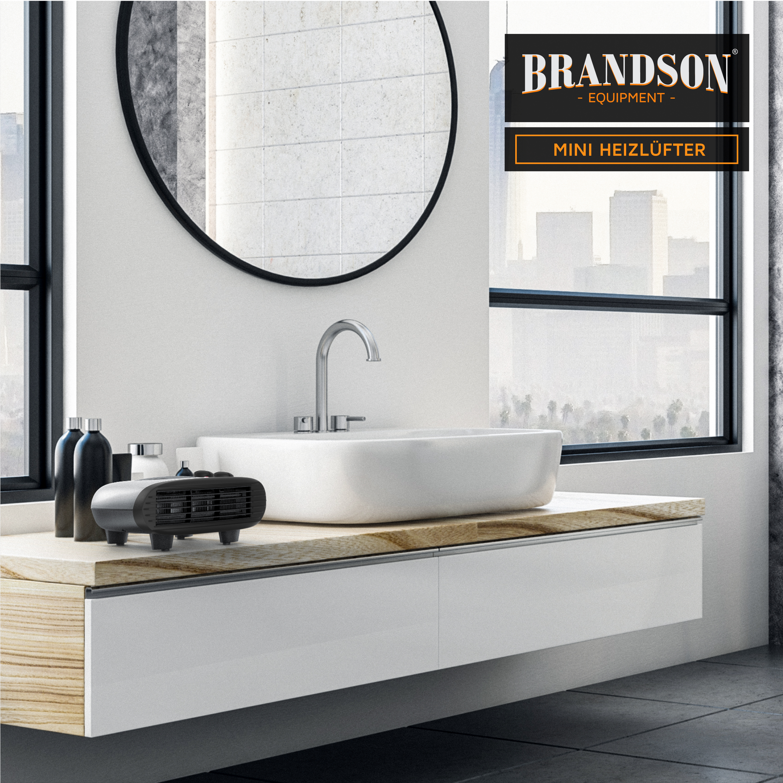 Brandson Mini Heizlüfter in Schwarz auf einem modernen Badezimmerwaschtisch mit runder Spiegelfläche und stilvollem Wasserhahn.